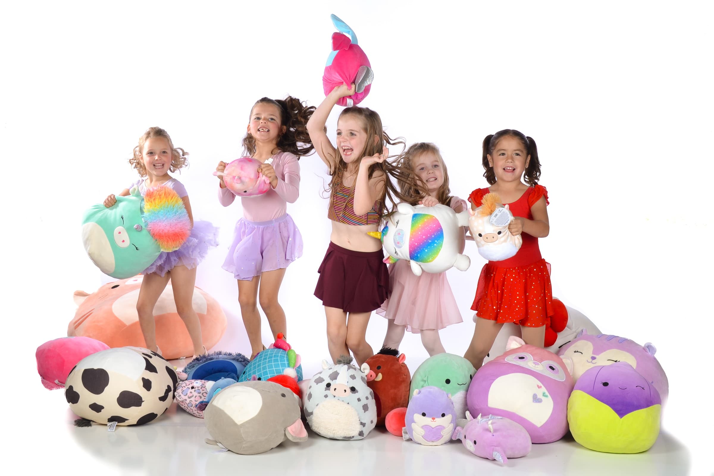 Young DanceSpace dancers jumping with plush toys