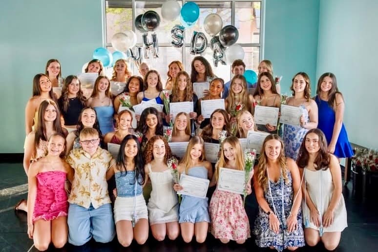 DanceSpace dancers at a National Honor Society for Dance Arts induction, holding certificates